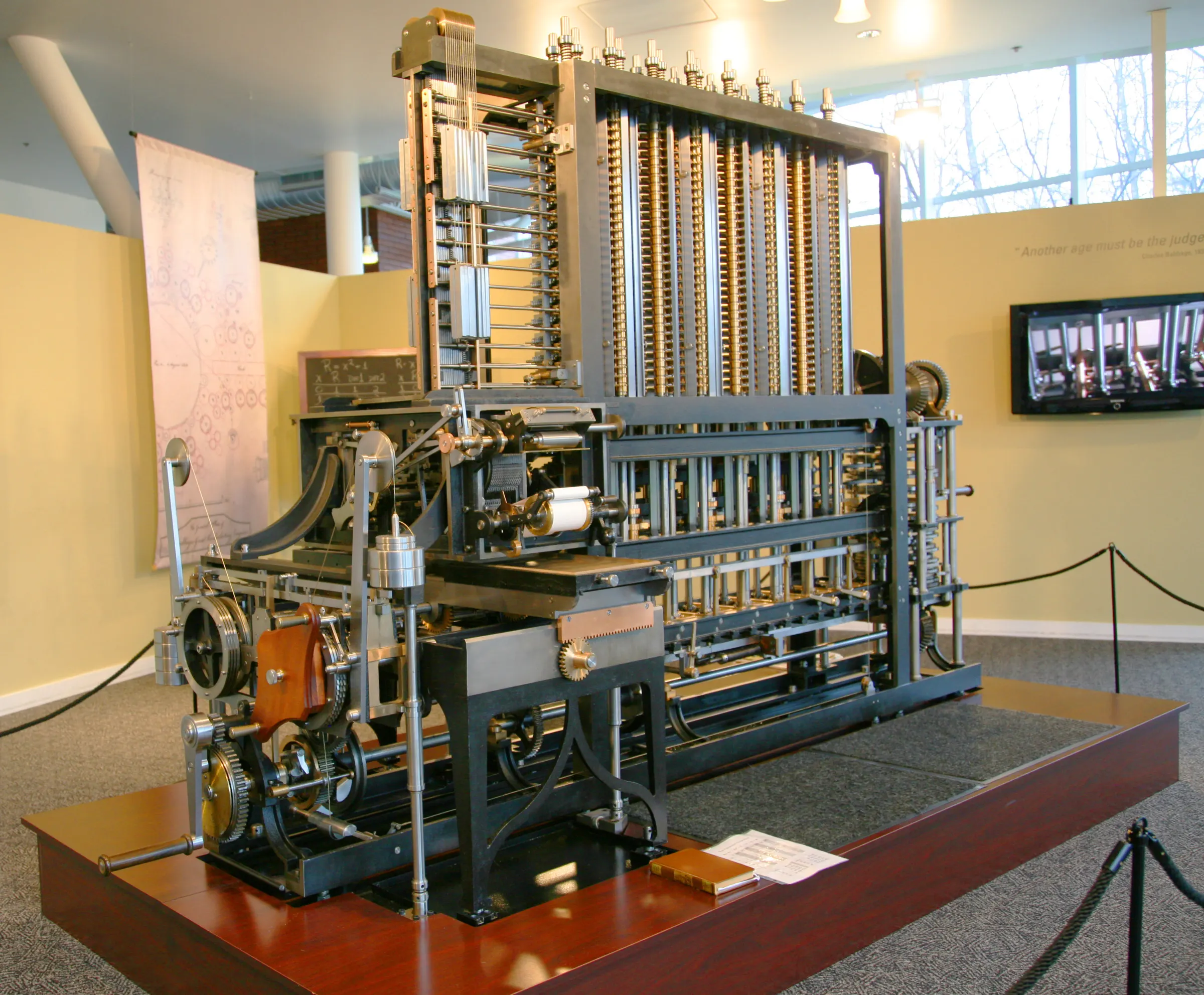 Brass columns of numbered gear wheels on a working Babbage Difference Engine