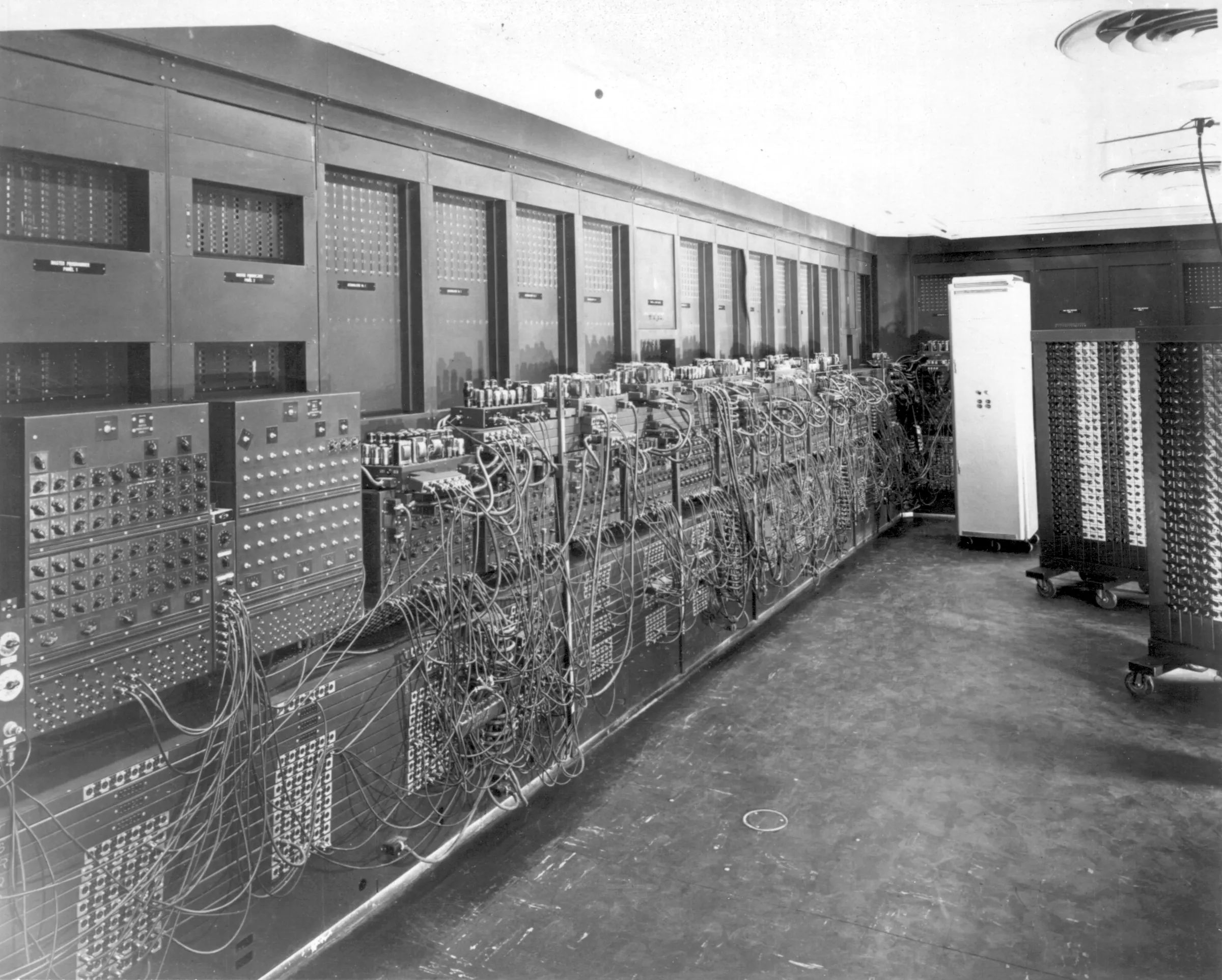 A long row of ENIAC panels covered in dials, switches and patch cables